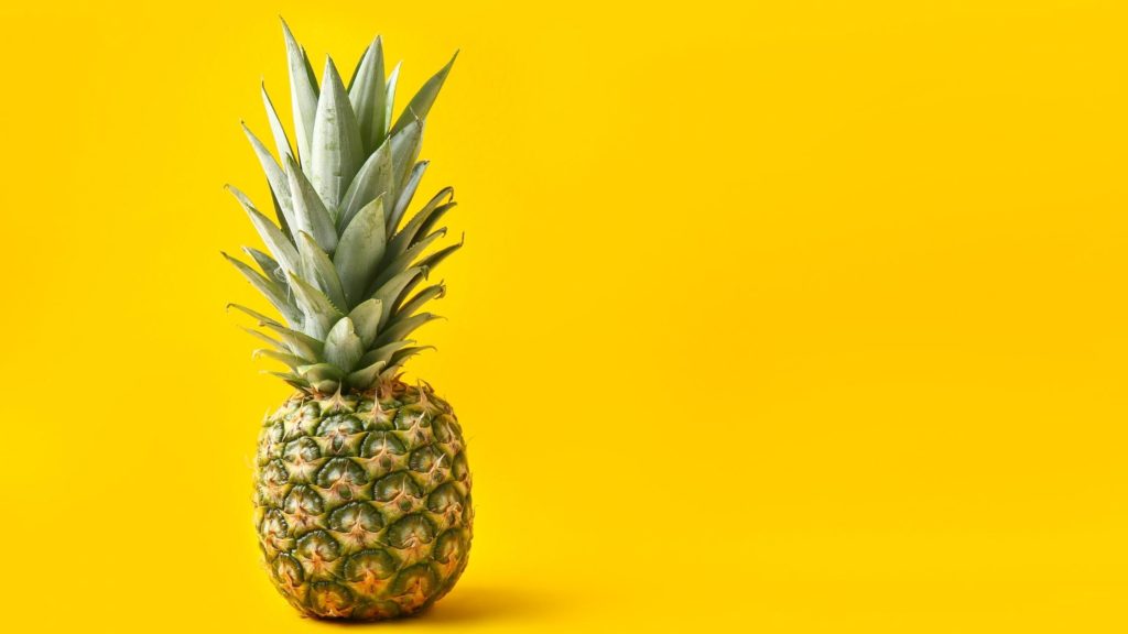 Pineapple with bright yellow background